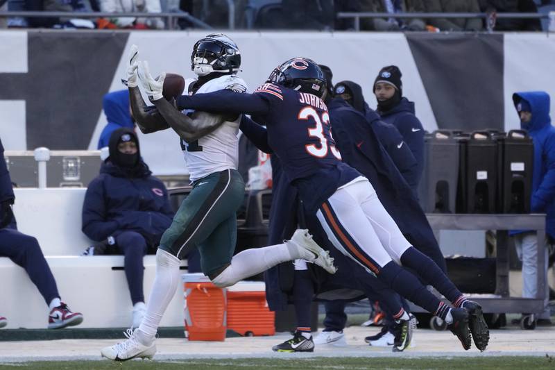 Philadelphia Eagles wide receiver A.J. Brown (left) catches a pass against Chicago Bears cornerback Jaylon Johnson during the second half, Sunday, Dec. 18, 2022, in Chicago.
