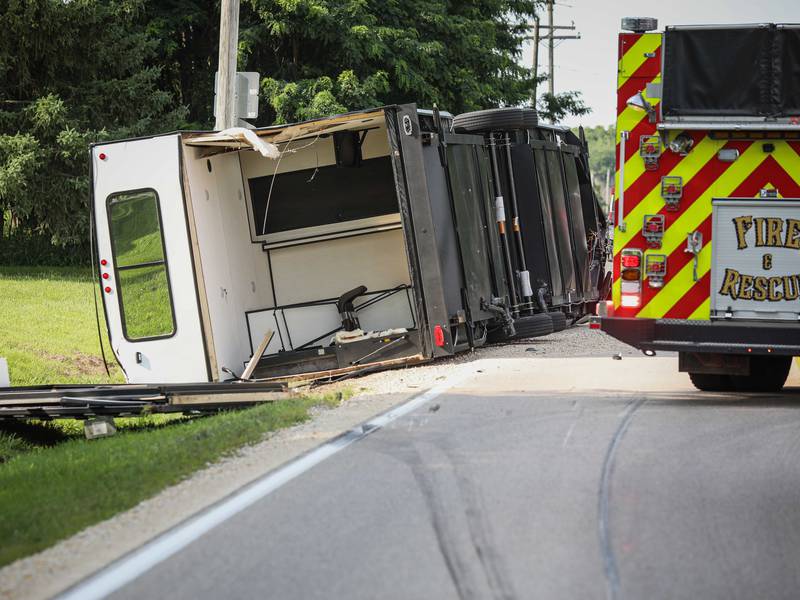 Driver injured after truck and trailer roll over near Harvard