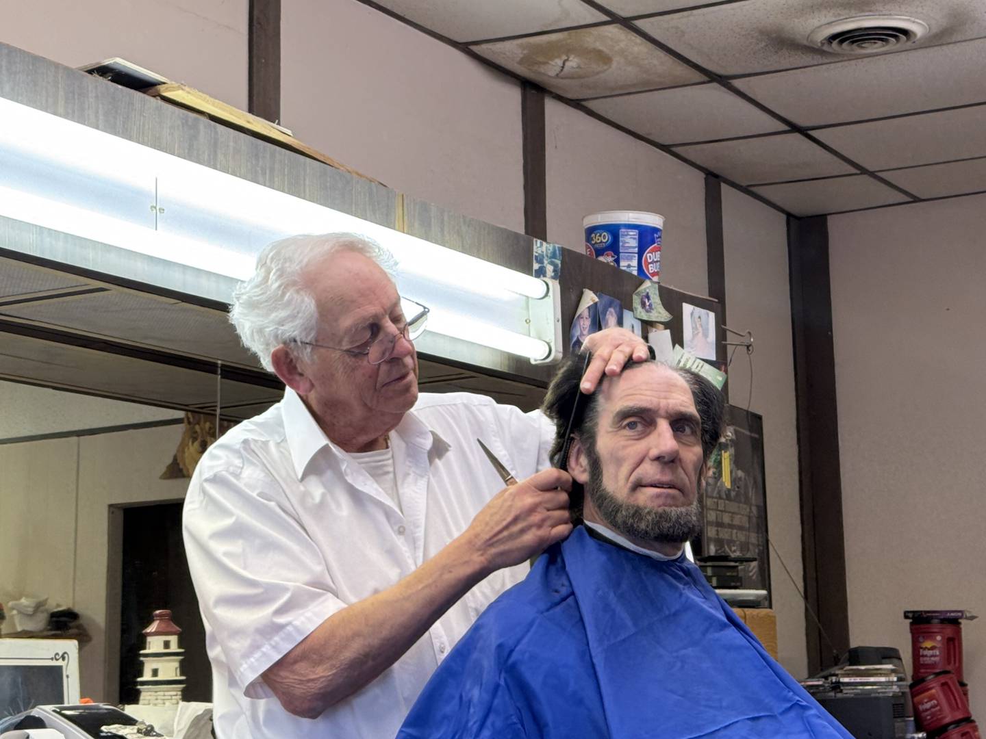 Dick Sohan works on Abraham Lincoln's hair on Thursday, Feb. 27.