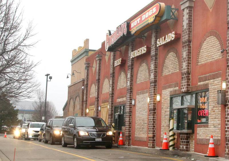 Vehicles wait in line to pick up their food Tuesday in the Portillo's drive-thru at 1780 DeKalb Ave. in Sycamore.