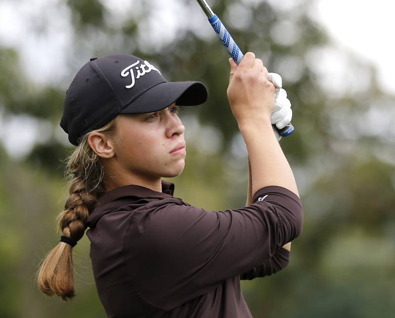 Jacobs’ Natalie Zimmerman watches her tee shot on the 13th hole during the Fox Valley Conference Girls Golf Tournament Wednesday, Sept. 24, 2025, at Crystal Woods Golf Club in Woodstock.