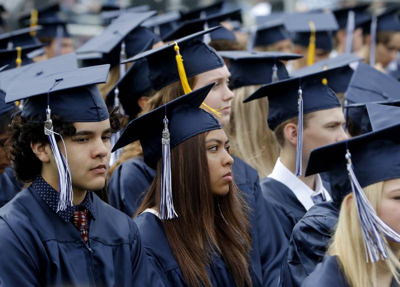 Graduates listen to Cary-Grove Principal Neil Lesinski speak during the graduation ceremony for the class of 2023 at Cary-Grove High School in Cary.