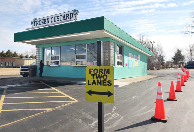 Signs point customers into separate lines at Ollie's Frozen Custard on opening day at the shop Tuesday, March 1, 2022, in Sycamore.
