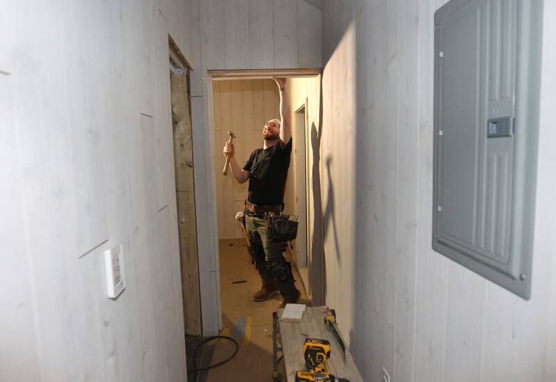 Joseph Luszcz, of Palatine, lead carpenter, works on a pocket door to the bedroom of a Milla Long, the largest unit of a prefabricated tiny home with 456 sq.ft., under construction for a customer in Stowe, Vermont at the Prefab Pads LLC factory in Waukegan on July 17th, 2023.
Image by Candace H. Johnson for Shaw Local News Network