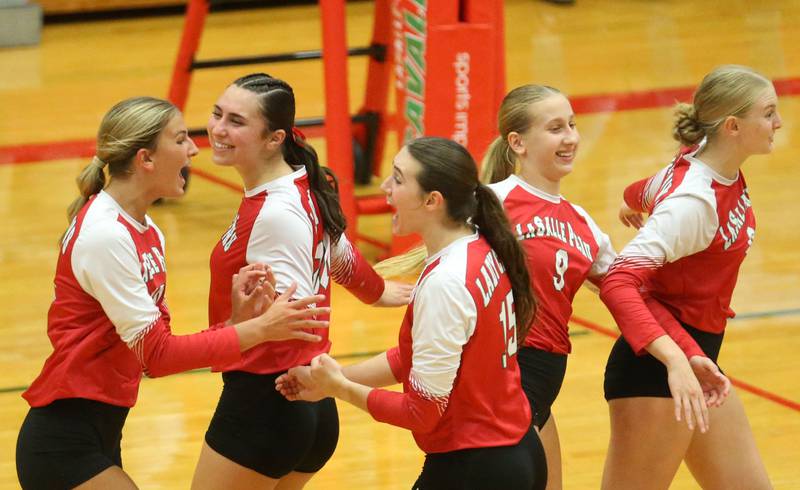 L-P volleyball players (from left) Kelsey Frederick, Anna Riva, Drew Depenbrock, Aubrey Urbanski and Maggie Boudereau all celebrate a victory after defeating Sycamore on Tuesday, Sept. 23, 2025 in Sellett Gymnasium at L-P High School.
