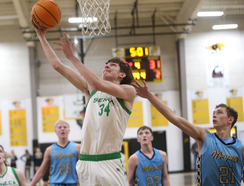 Seneca's Patrick Griffin runs past Marquette's Lucas Craig to score a bucket during the Tri-County Conference championship on Friday, Jan. 31, 2025 at Putnam County High School.