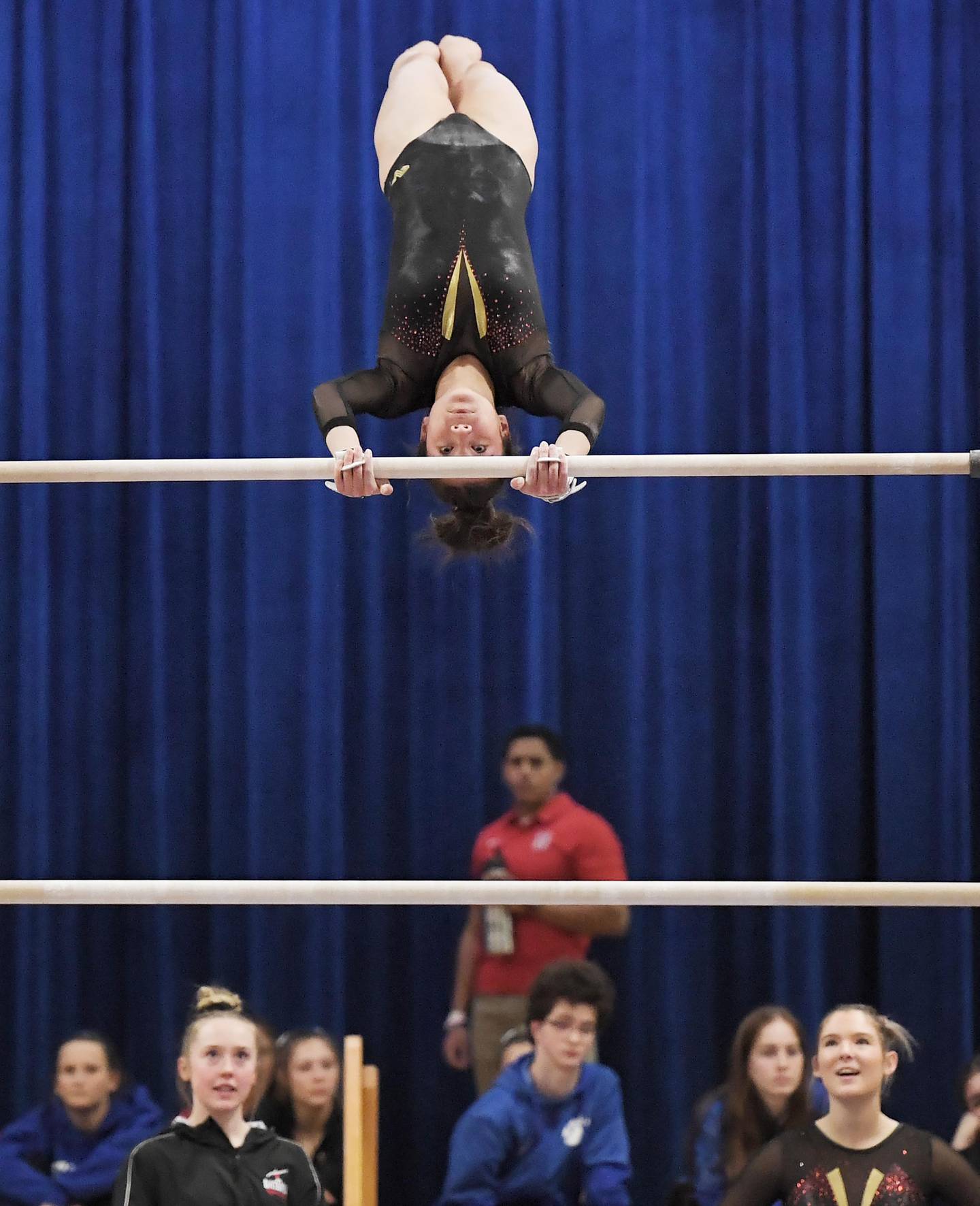 Batavia’s Wynne Tien performs on the bars at the Geneva girls gymnastics regional meet in Geneva on Wednesday, February 1, 2023.