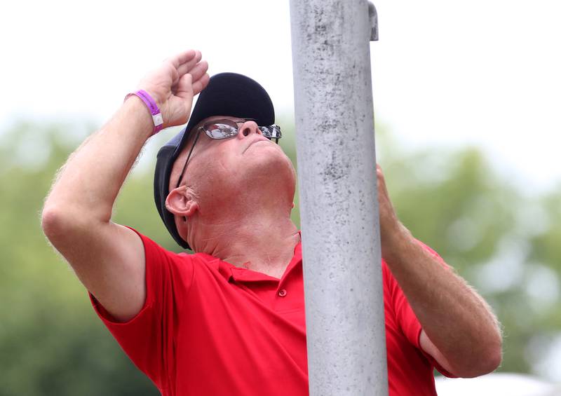 Veteran Arthur Foltynewicz, with the Sons of the American Legion Squad 33 in Ottawa, salutes while raising the American Flag during the National Anthem US Title Series (USTS) Pro National Championship Boat Races on Friday, July 25, 2025 in DePue.