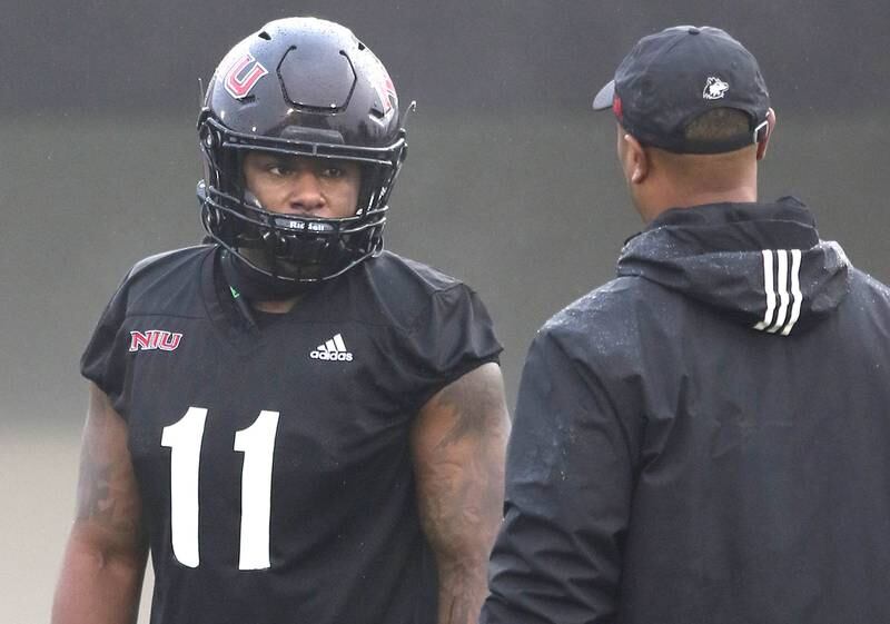 Northern Illinois University linebacker Kyle Pugh talks to a coach during spring practice Wednesday, March 23, 2022, at NIU in DeKalb.