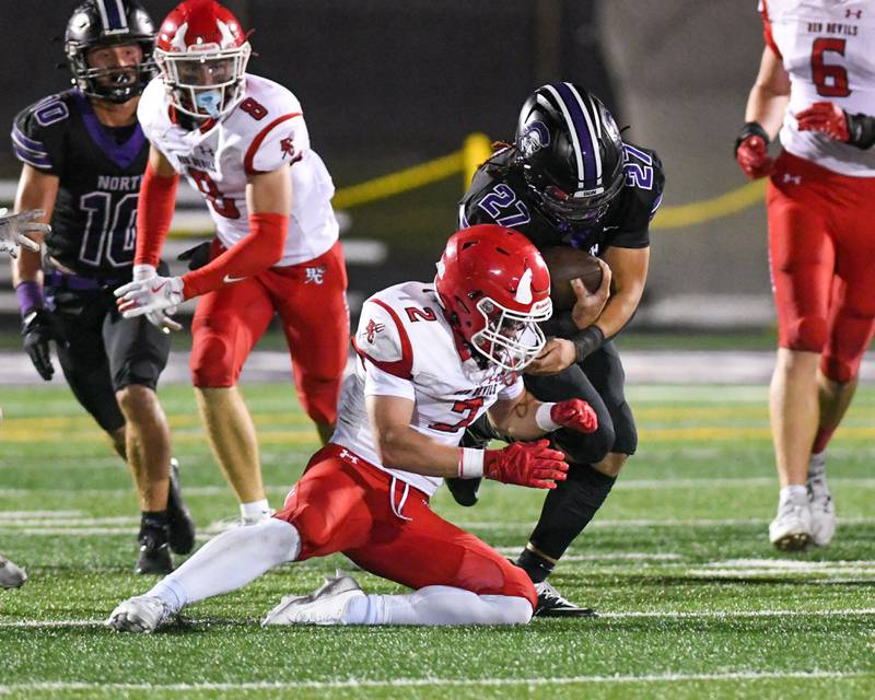 Hinsdale Central's Patrick Connors (2) brings down Downers Grove North's ball carrier Kevin Jay Jr. (27) during the game on Friday Sept. 12, 2025, held at Downers Grove North High School.