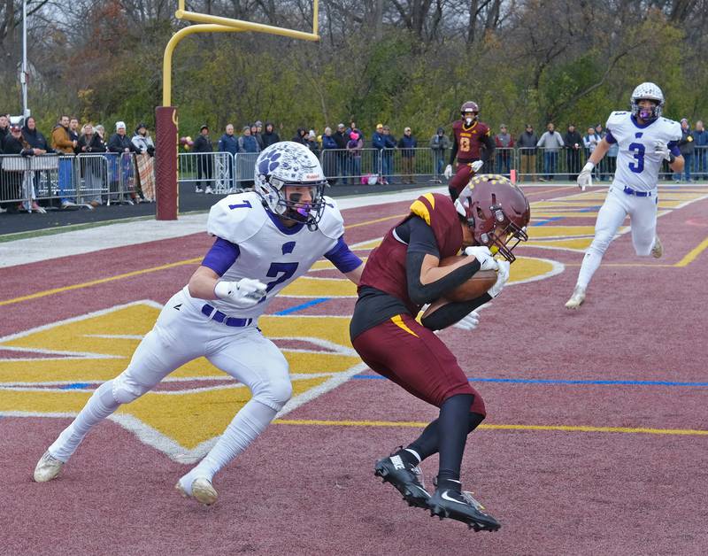 Montini's Santino Florio catches a touchdown pass as Wilmington's Hunter Osipavicius (7) defends during a Class 3A semifinal game on November 23, 2024 at Montini Catholic High School in Lombard.