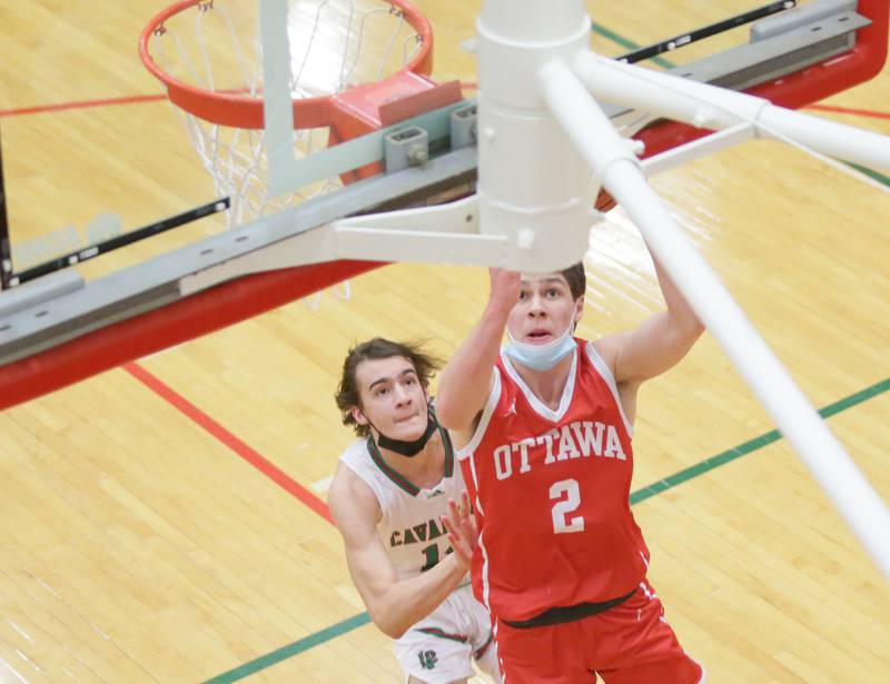 Ottawa's Luke Cushing (2) runs in for a basket as L-P's Tyler Wrobleski (14) trails on Friday, Feb. 11, 2022, at L-P.