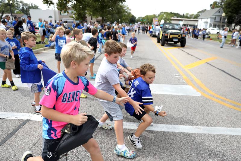 Kids scramble for candy on Friday, Sept. 27, 2024 during Geneva High School’s annual homecoming parade.