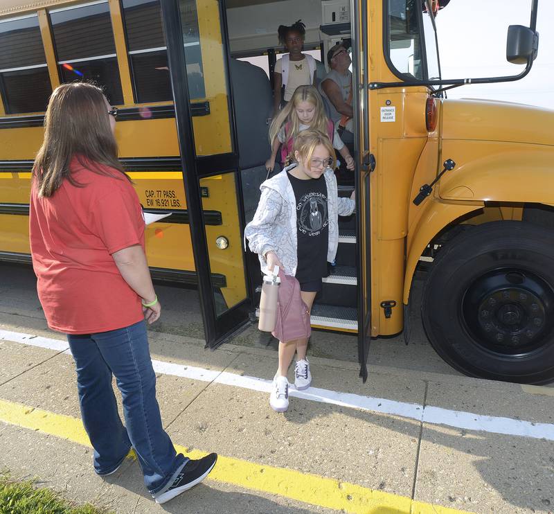 Students leave the school bus as they begin their first day of school at Centennial Wednesday in Streator.