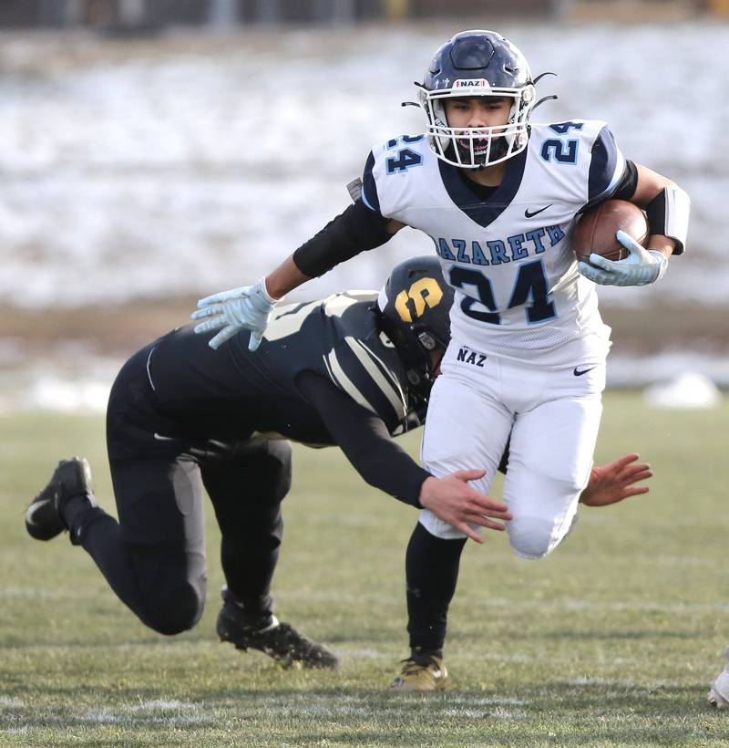 Nazareth's Alexander Angulo sheds the tackle of Sycamore's Joey Ward Saturday, Nov. 18, 2022, during the state semifinal game at Sycamore High School.