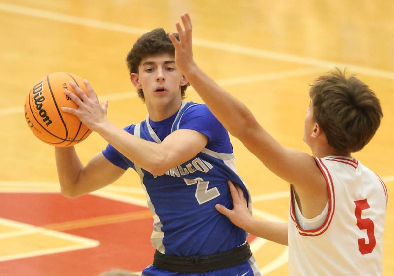 Princeton's Noah Gutshall looks to pass the ball off as Ottawa's Rory Moore defends during the Dean Riley Shootin' The Rock Thanksgiving Tournament on Monday Nov. 24, 2025 in Kingman Gymnasium at Ottawa High School.