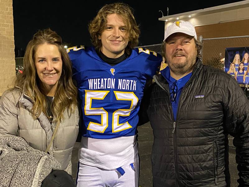 Chuck Neidballa (52) is a starting linebacker for the Wheaton North football team headed to the state championship game for the first time since 1986 when his dad, David (right) played for the Class 5A state champion Falcons.