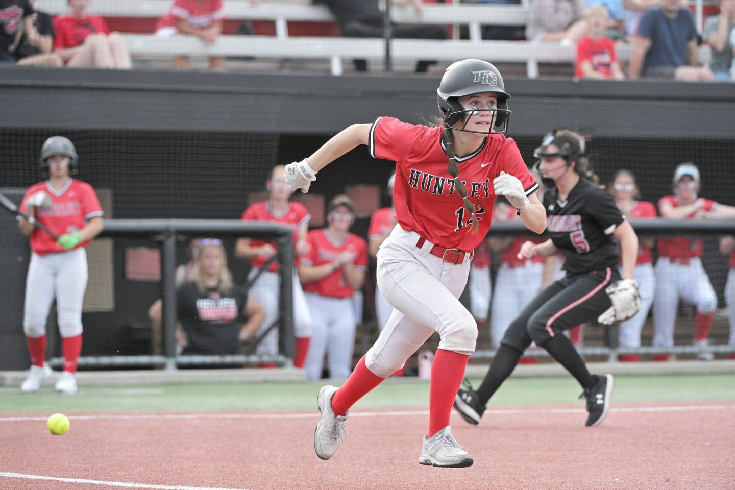 Huntley’s Aubrina Adamik runs safely to first with a bunt against Mundelein in the sixth inning in the IHSA Class 4A softball supersectional game at The Ballpark at Rosemont on Monday, June 3, 2024.