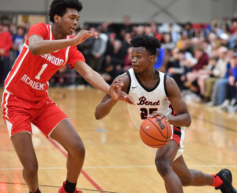 Benet's Ewola Moukoulou drives the baseline as Kenwood's Jaden Smith (1) defends during a "When Sides Collide" invitational game on Jan. 21, 2023 at Benet Academy in Lisle.
