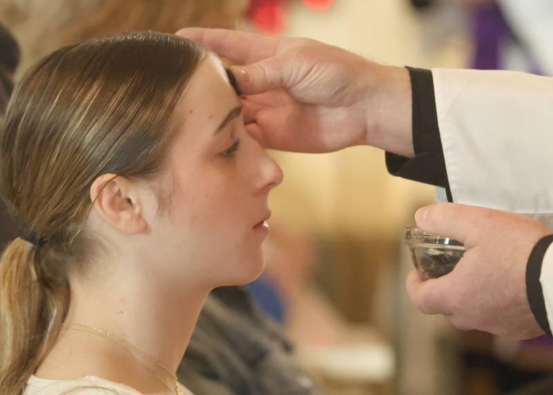 Kiley Domyancich of La Salle, receives ashes during Ash Wednesday Mass on Wednesday, Feb. 18, 2026 at The Queen of the Holy Rosary Memorial Shrine in La Salle. Ash Wednesday marks the beginning of Lent leading up to observances of Jesus' death on Good Friday and resurrection on Easter.