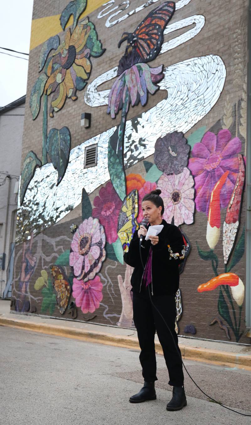 Mural artist Danielle Casali speaks Thursday, Oct. 19, 2023, during the unveiling and ribbon cutting of the new City Hall mural she created. The mural is on the on the south wall of City Hall and was completed with the help of many volunteers who wanted to be a part of the project..
