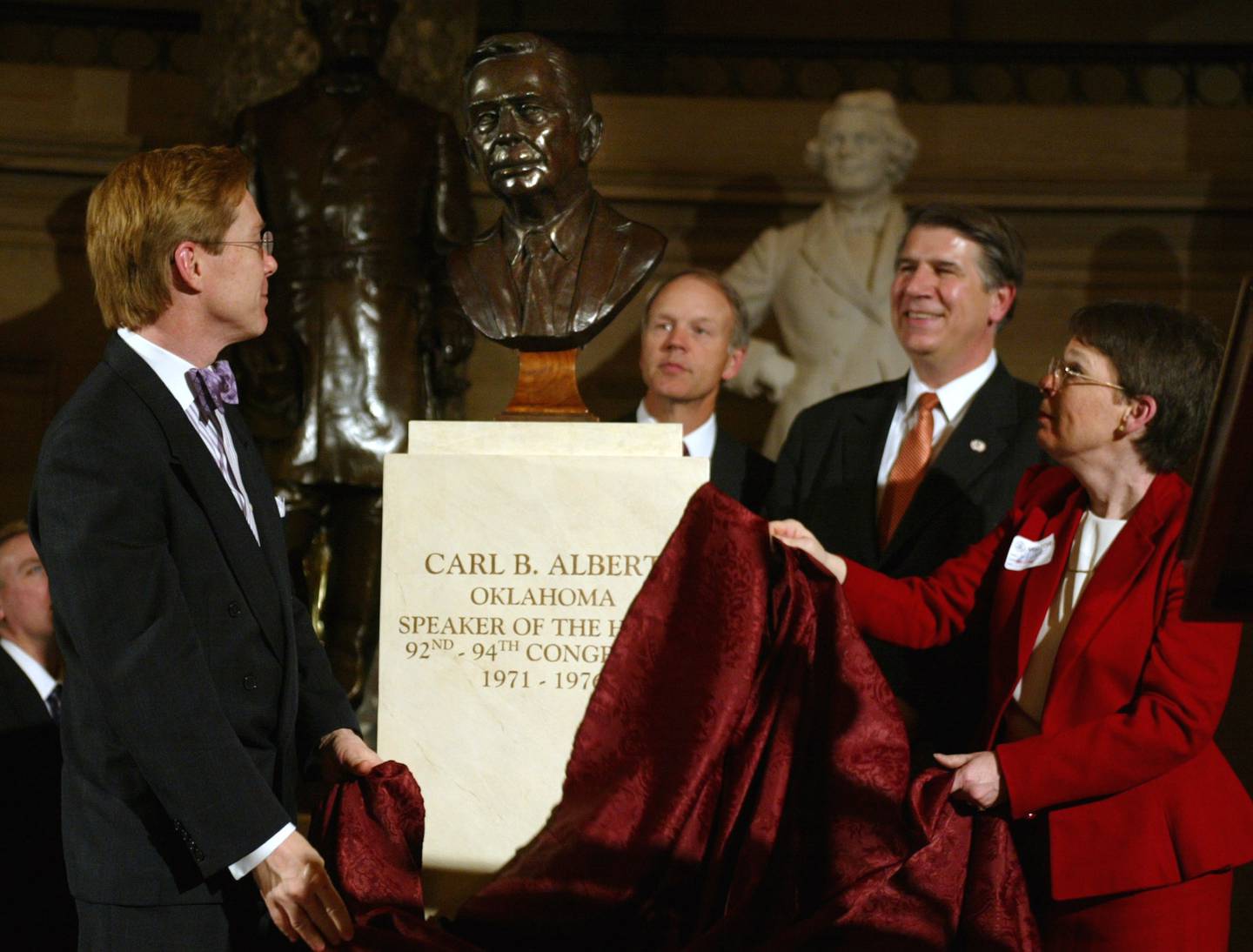 Dr. David E. Albert (left) and his sister Mary Frances Albert (right), with Rep. Ernest Istook, R-Okla., (second from right) and Sen. Don Nickles, R-Okla., (third from right), unveil a bronze bust of their father, former House Speaker Carl Albert, an Oklahoma native and 46th House Speaker, at the Capitol on March 3, 2004, in Washington.