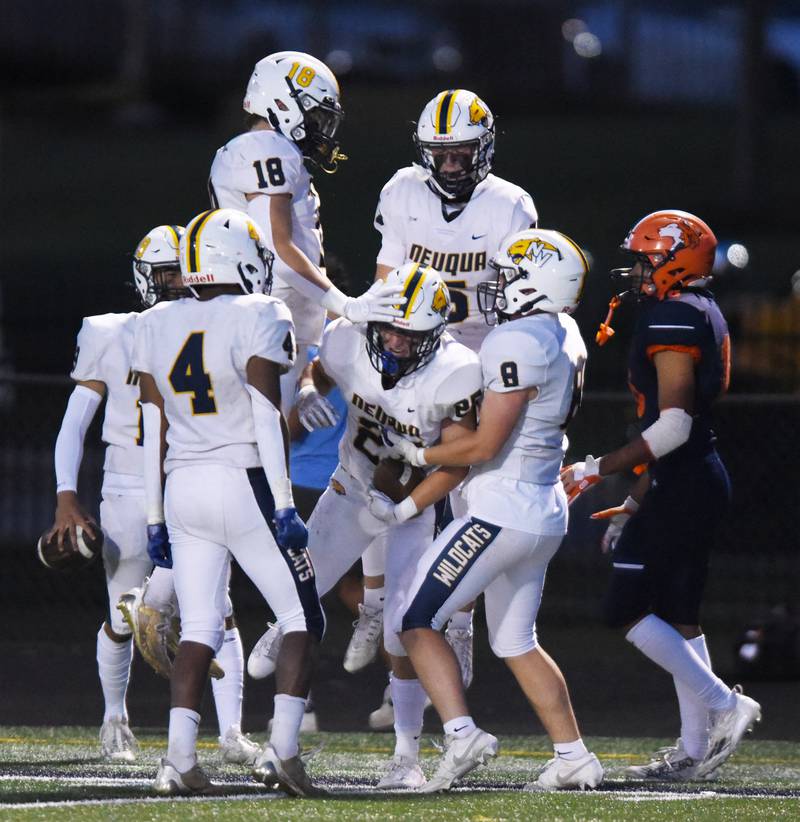 Joe Lewnard/jlewnard@dailyherald.com
Neuqua Valley’s Andrew Hoffman, middle, celebrates with his teammates after intercepting a pass during Friday’s game at Naperville North.