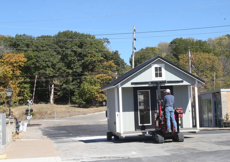 Crews move huts into the retail site plaza on Wednesday, Oct. 16, 2024 downtown Utica.