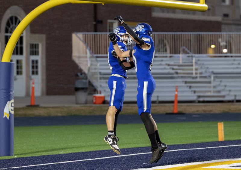 Newman’s Matthew Blackert (left) and John Rowzee celebrate an opening drive touchdown against Orion to put the Comets up early Friday, Sept. 20, 2024, at Roscoe Eades Stadium in Sterling.