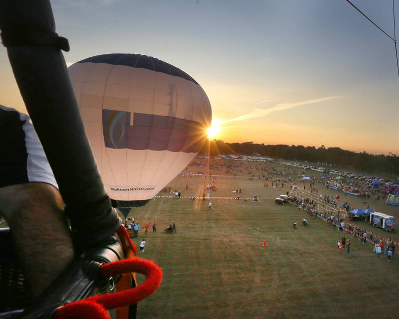 The sun sets behind a hot air balloon during the 52nd annual Homestead Festival at Zearing Park on Saturday, Sept. 9, 2023 in Princeton.