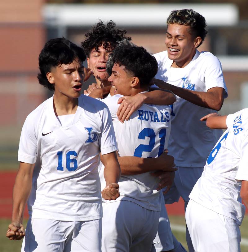 Larkin’s Atlai Gutierrez, front, pumps his fists as the Royals celebrate a first-half goal against Huntley in boys soccer regional action at South Elgin on Saturday.