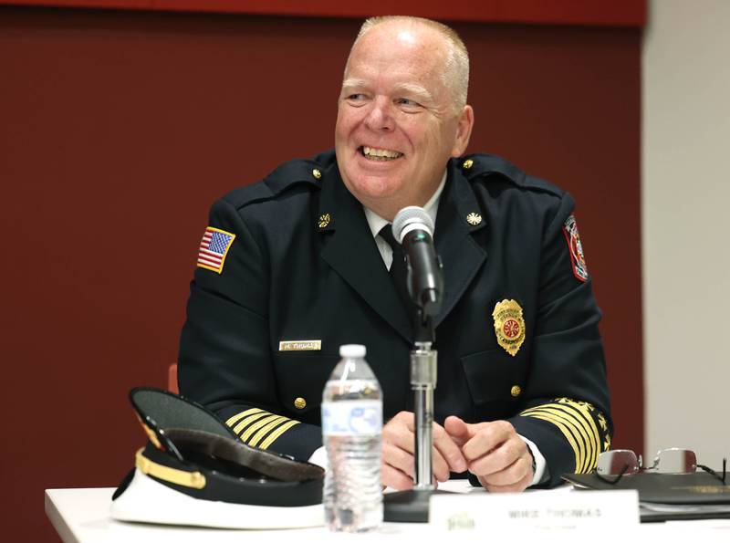 Retiring DeKalb Fire Chief Mike Thomas smiles Monday, June 23, 2025, as his wife is introduced during the DeKalb City Council meeting at the DeKalb Public Library.
