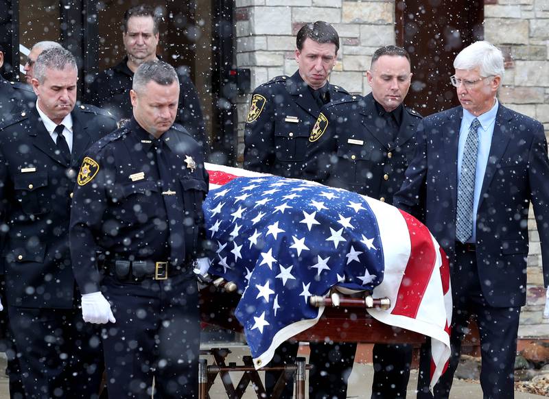 The casket of former DeKalb County Sheriff Roger Scott is brought out of the church by a detail of law enforcement officers Friday, March 7, 2025, following his memorial service at Bethany Road Bible Church in DeKalb. Scott, who was the county sheriff for 36 years, died on February 23 at the age of 78.