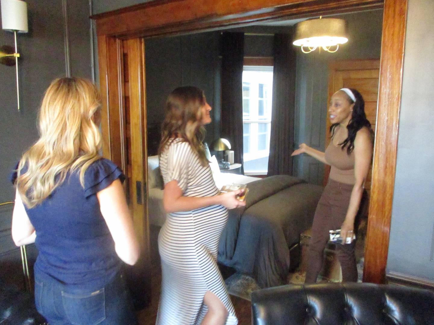 Thalia Duke (right), project manager for The Banks Bridal Suites & Lodging in Joliet shows visitors rooms at the bouquet hotel during an opening ceremony on Thursday. April 23, 2026