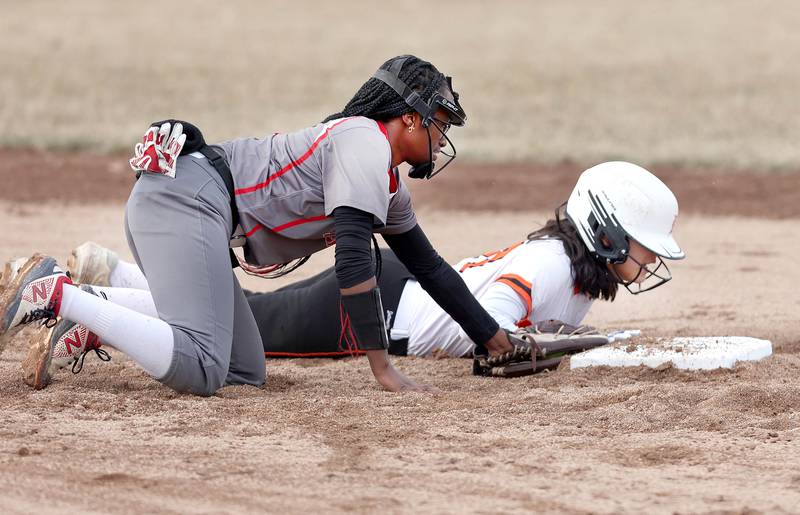 DeKalb’s Isabel Aranda gets back to second just ahead of the tag of Rockford Auburn’s Za’Kaiya Hudson during their game Wednesday, March 15, 2023, at DeKalb High School.