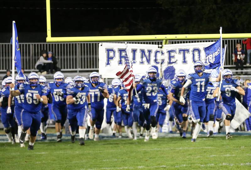 Members of the Princeton football team run onto Bryant Field during the first-round of the Class 3A playoffs against Oregon on Friday, Nov. 1, 2024 at Princeton High School.