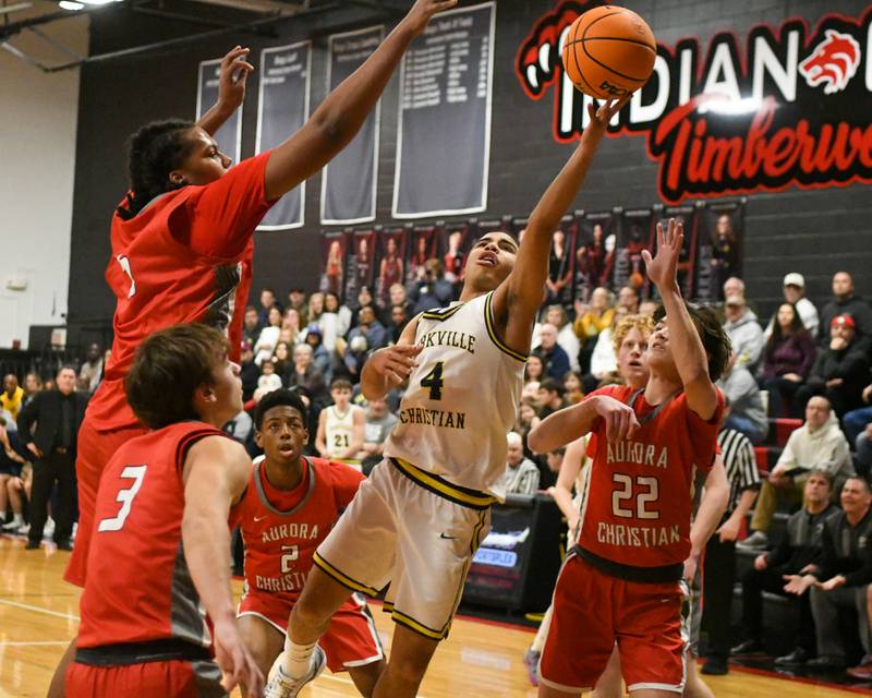 Yorkville Christian's Tray Alford (4) takes a shot during the game while defended by Aurora Christian players during the game on Friday Feb. 28, 2025, held at Indian Creek High School.