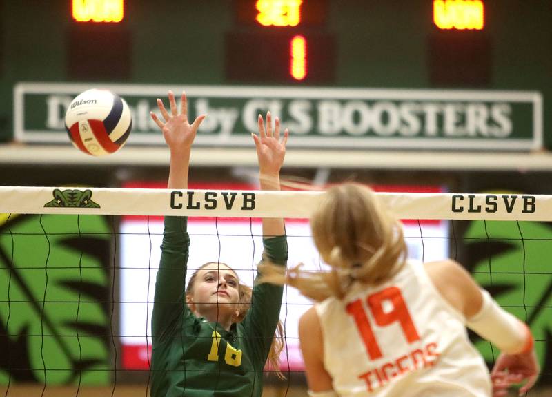 Crystal Lake Central’s Alexis Hadeler, right, hits the ball past Crystal Lake South’s Sedona Semradek  in varsity volleyball at Crystal Lake South High School in Crystal Lake on Tuesday, Oct. 7, 2025.