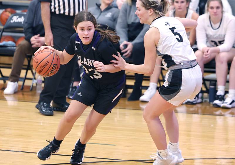 Plano’s Josie Larson drives by Kaneland’s Brigid Gannon during their game Tuesday, Dec. 13, 2022, at Kaneland High School in Maple Park.