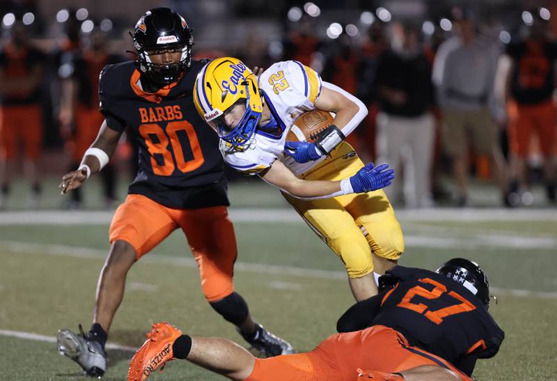 DeKalb’s Daniel Roman-Johnson and Justin O’Neal bring down a Sandburg ball carrier during their game Friday, Sept. 8, 2023, at DeKalb High School.