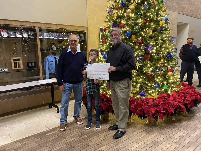 Milo S. donates $1,000 to the Grundy County Veterans Assistance Commission as a winner in the Community Foundation of Grundy County's essay contest.
