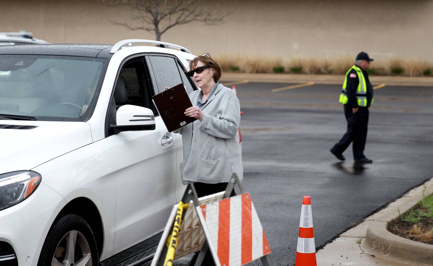 Volunteer Jan Fulfs gives out information during a drive-thru event to kick off the Kane County Health Department’s 988 Suicide and Crisis Lifeline awareness campaign on Friday, April 25, 2025 in the parking lot of the Kane County Circuit Clerk in St. Charles.