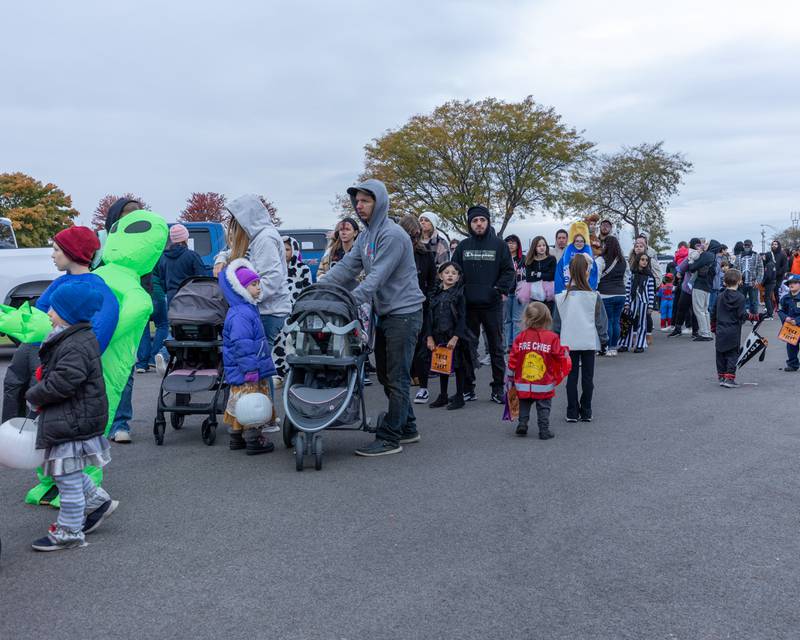 Hundreds of trick-or-treaters wait in line at the trunk or treat event on Saturday, October 25, 2025 at Illinois Valley Auto Group in Peru.