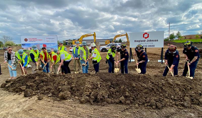 Active duty members of the Sycamore Fire Department stick shovels in the land that will in about nine months be home to a new fire station. City officials held a groundbreaking ceremony for the city's new fire station on Monday, May 5, 2025, at 1351 S. Prairie Drive, Sycamore.