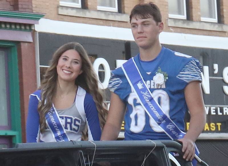 Sophomore attendants Gracie Norman and Carter Rossler ride during the Princeton High School homecoming parade on Thursday, Sept. 25, 2025 along South Main Street in Princeton .
