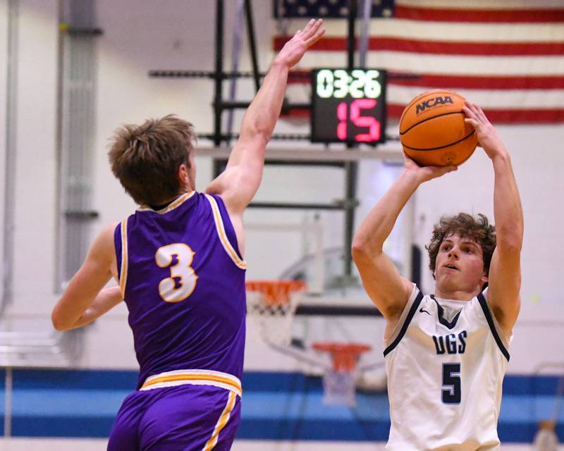 Downers Grove South's Wyatt Wawro (5) makes a three-point shot while being defended by Downers Grove North's Nolan Hurter (3) on Saturday Dec. 21, 2024, held at Downers Grove South High School.