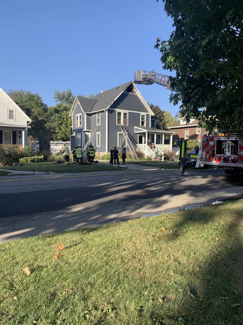 Firefighters from multiple departments work to extinguish a house fire at 118 E Van Buren St. in Ottawa, on Sunday, Oct. 6. One firefighter sustained minor injuries and a neighbor was treated for smoke inhalation after rescuing a dog from the home.