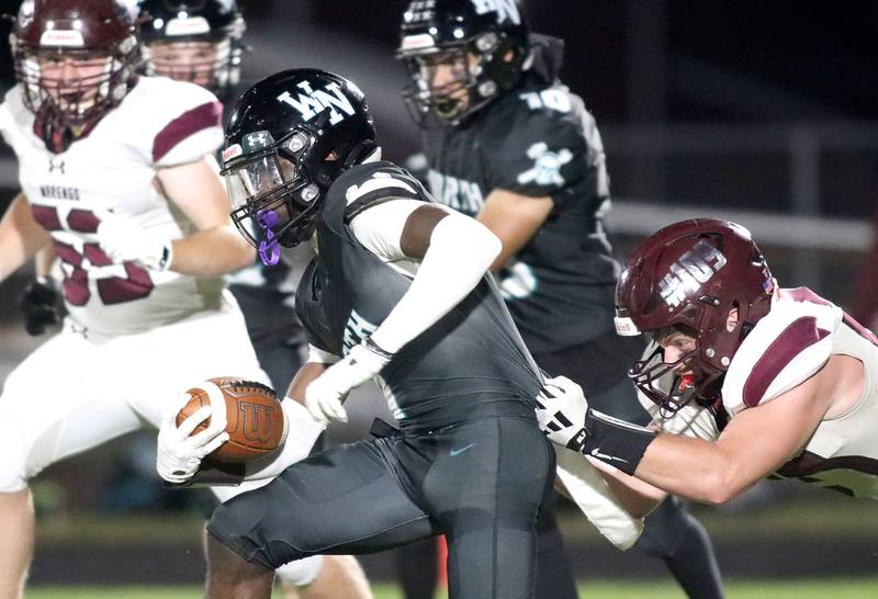 Marengo’s Connor Sacco, right, pursues ballcarrier from Woodstock North JR Fadahunsi in varsity football at Rod Poppe Field on the campus of Marengo High School in Marengo on Friday, Sept. 12, 2025.