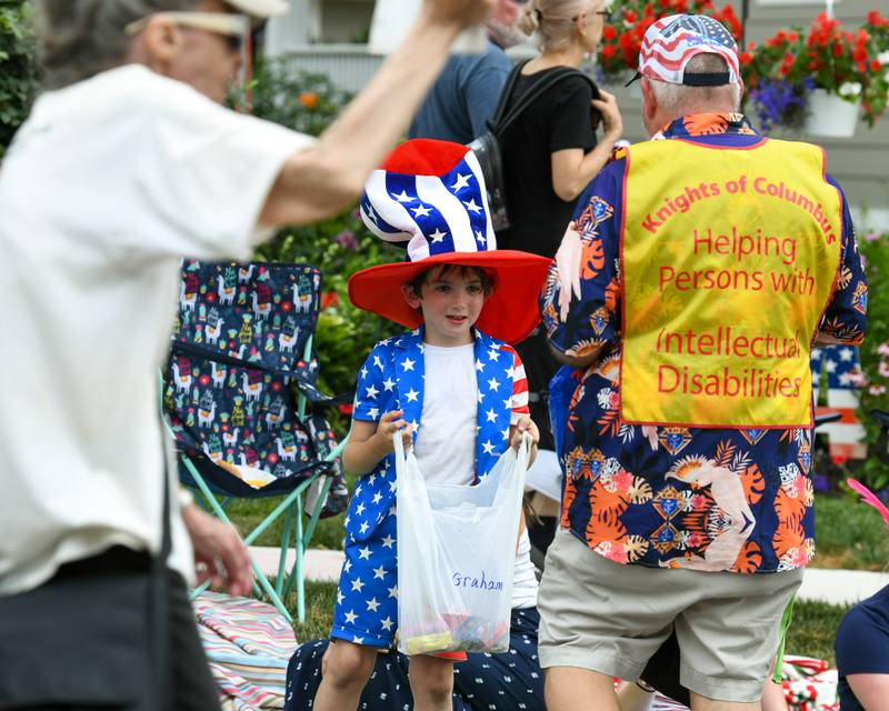 Graham McCann, 8, of Geneva, waits patiently for some candy from the Knights of Columbus during the Independence Day Parade on Friday July 4, 2025, held in downtown Downers Grove.
