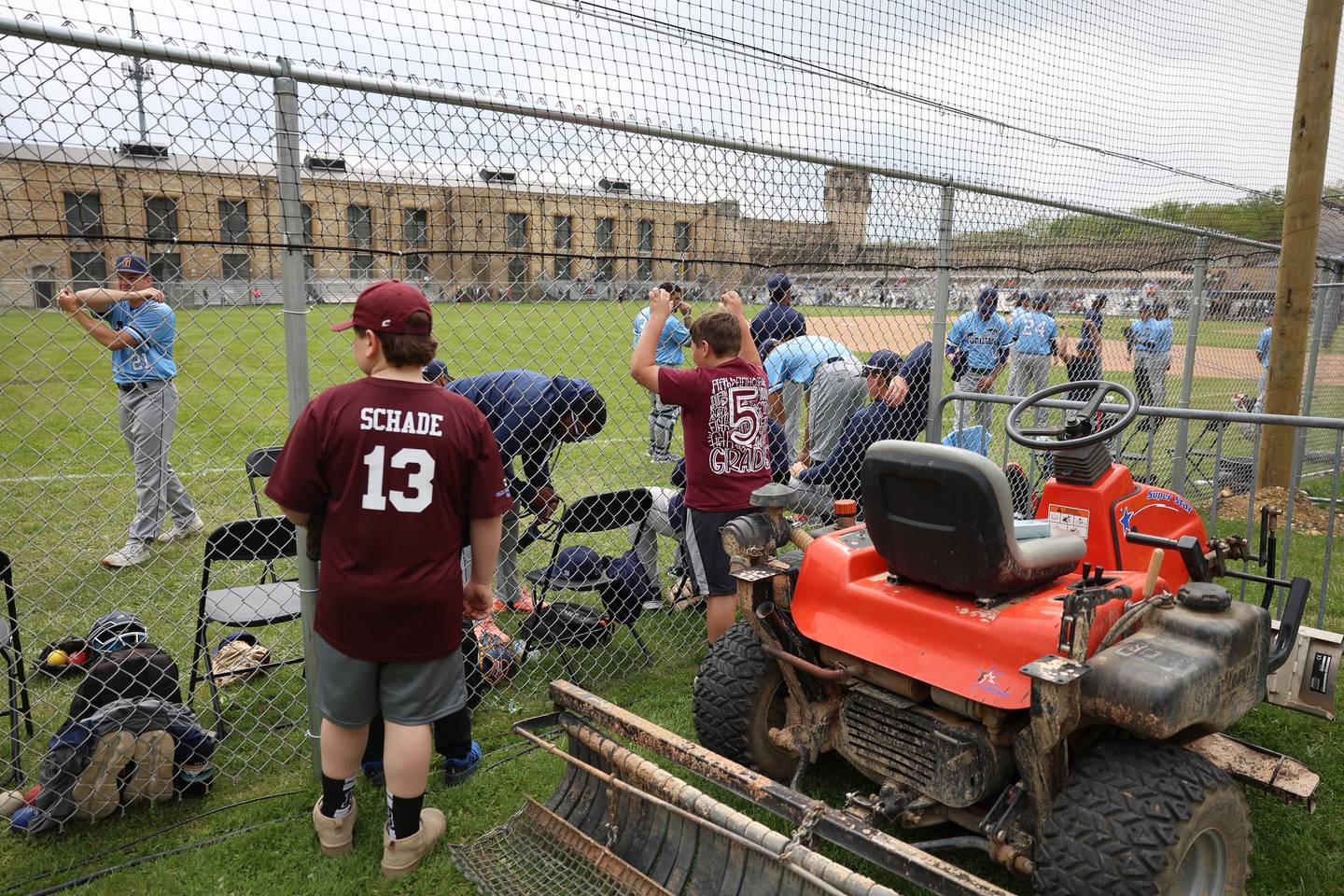 Kids watch players warm up before the Joliet Slammers preseason game at the Old Joliet Prison on Thursday, April 29, 2026 in Joliet.
